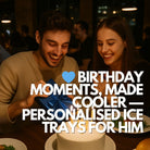 A happy man unwraps a present with his partner beside a birthday cake, symbolising heartfelt gifting. The overlay text reads “Birthday Moments, Made Cooler — Personalised Ice Trays for Him,” reinforcing thoughtful and unique gift intent.