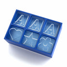 Blue custom ice tray showing raised 'A' cubes alongside heart, star, and flower – handmade and ideal for cocktail lovers