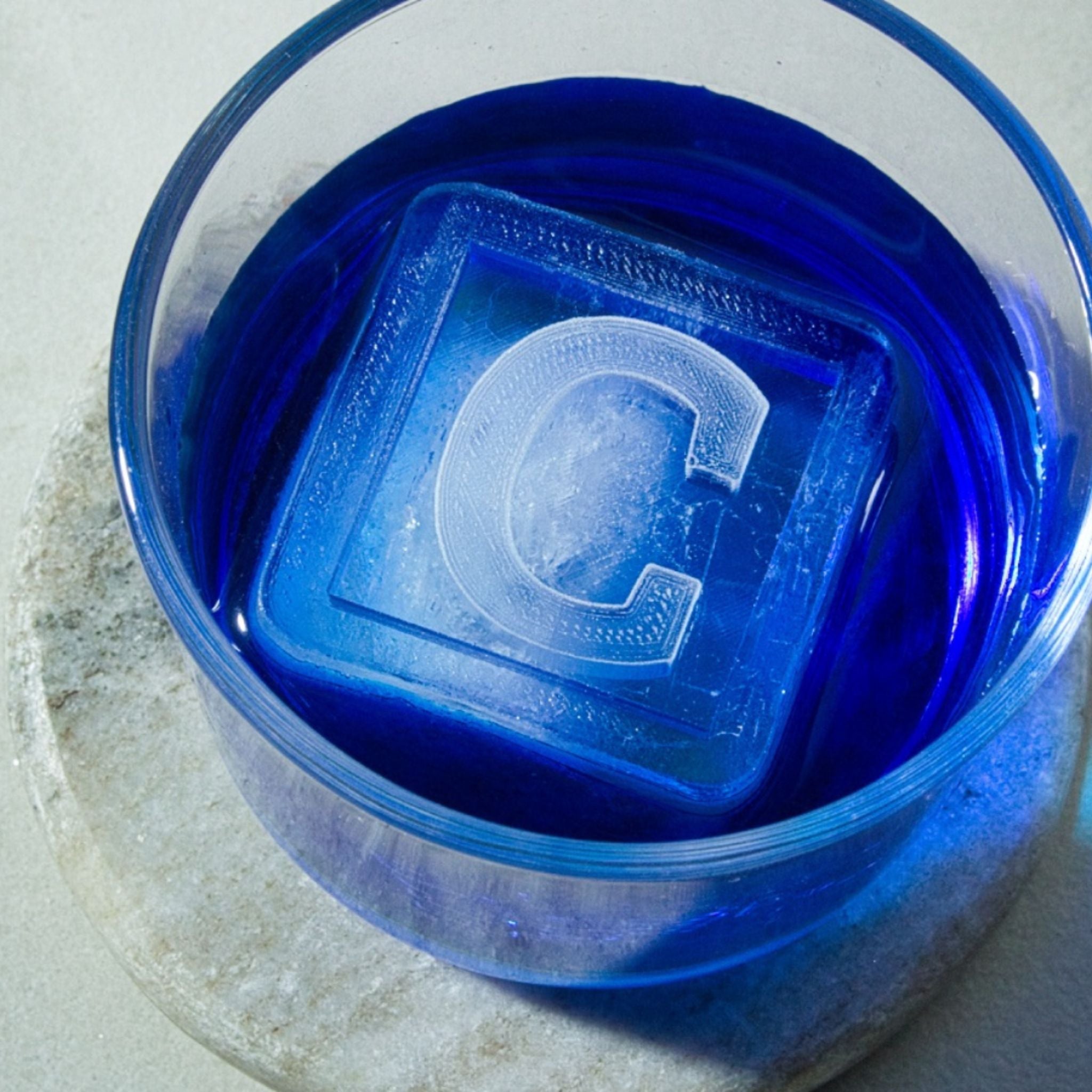 Large “C” ice cube in blue glass, a memorable gift for men who love a personal touch