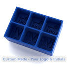 Close-up of a royal blue silicone ice tray featuring monogrammed initials and custom logo cavities for unique personalised ice cubes.