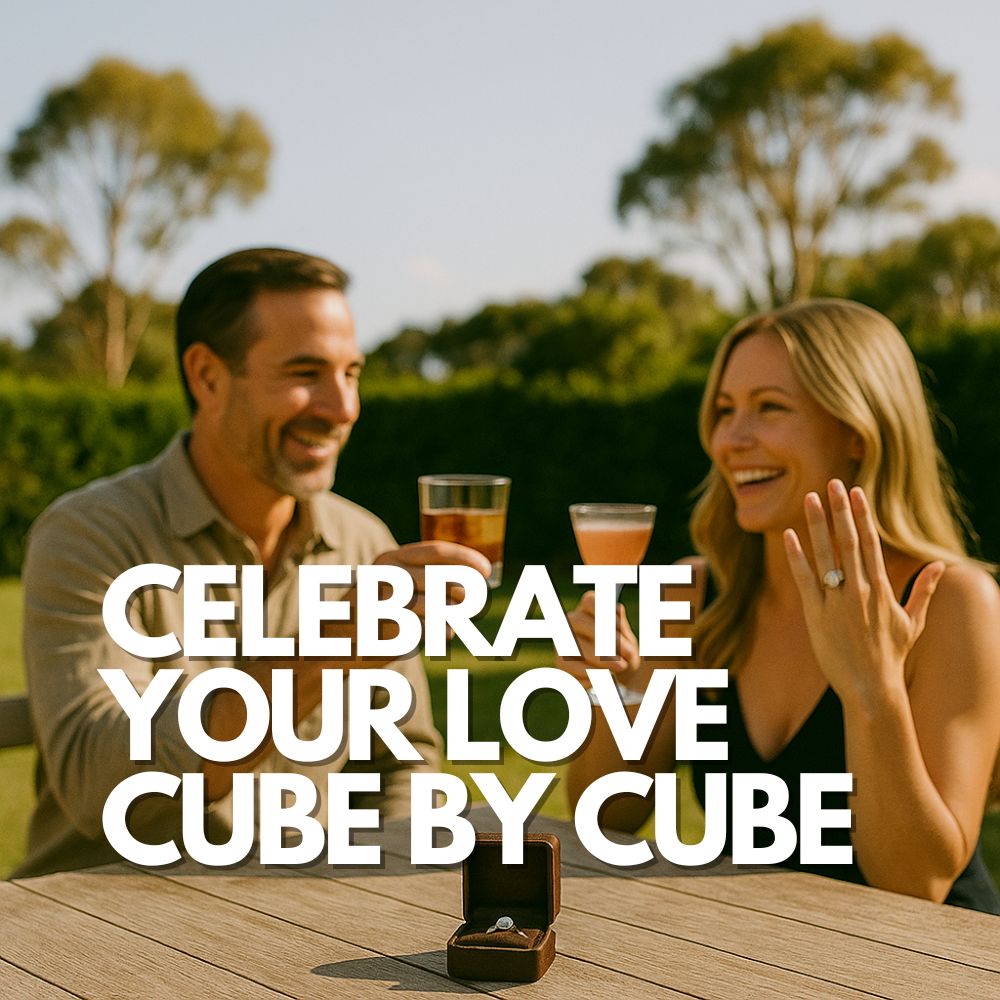 Couple celebrating their engagement outdoors with drinks featuring custom ice cubes, engagement ring in focus on the table, with bold text overlay reading “Celebrate Your Love – Cube by Cube.”