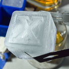 Detailed view of a handmade letter X ice cube, perfect for premium drinks, barware gifts, and unique entertaining.
