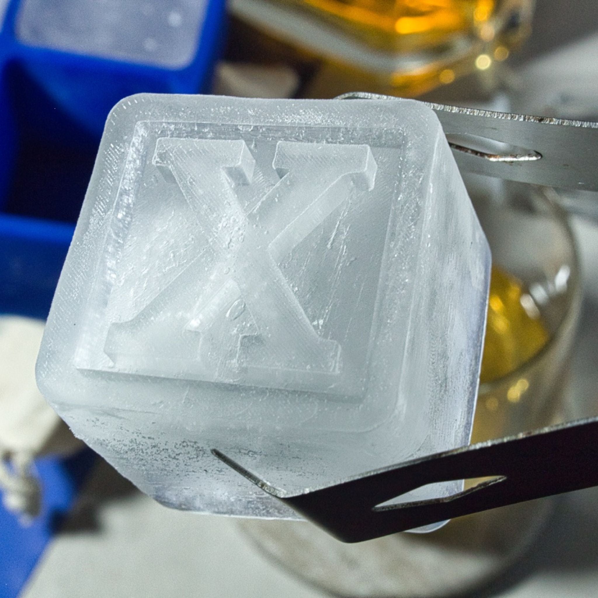 Detailed view of a handmade letter X ice cube, perfect for premium drinks, barware gifts, and unique entertaining.