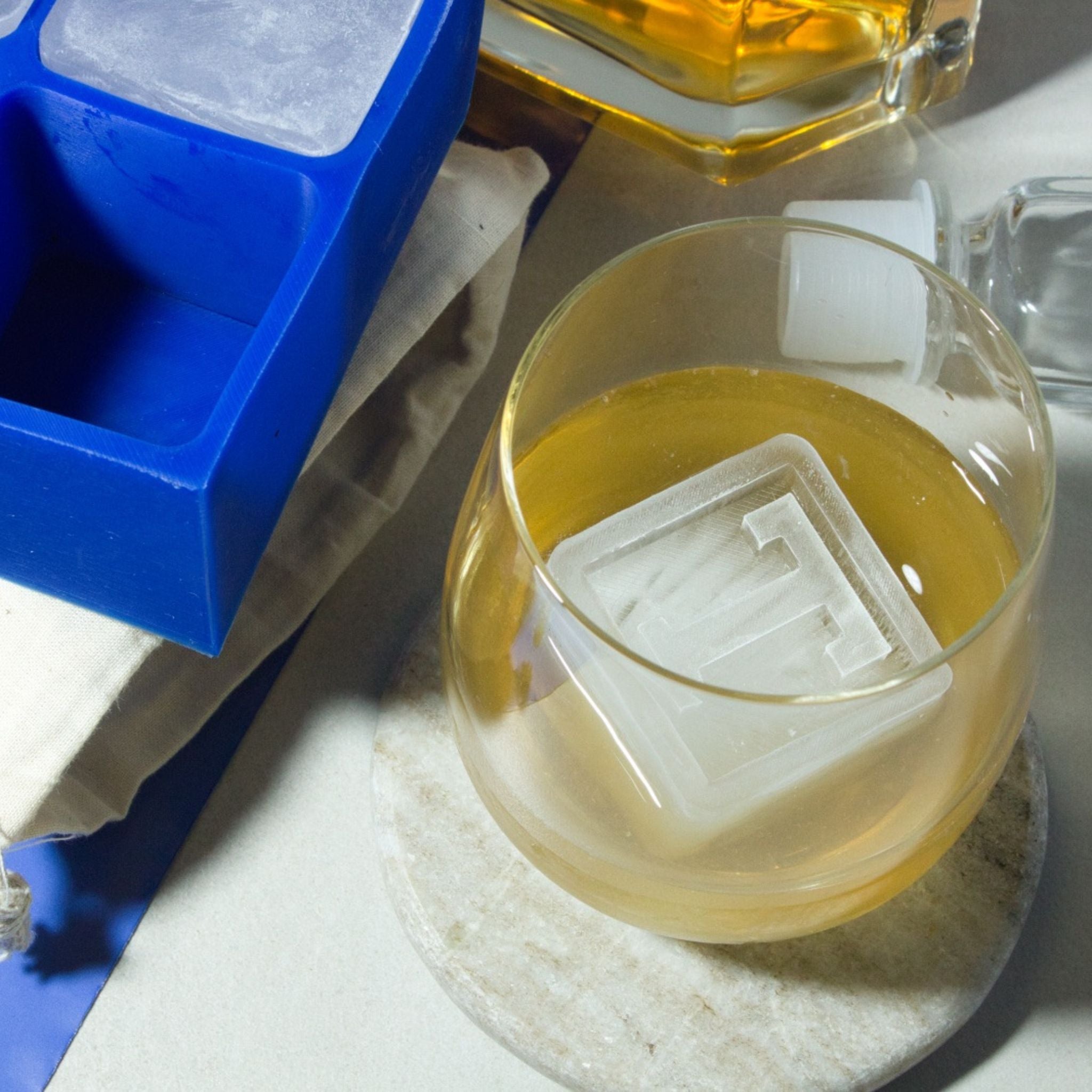T’ monogram ice cube in a whiskey glass – a creative and memorable gift for milestone birthdays or special celebrations.