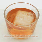 Amber whiskey with custom EST date ice cube featuring EST 2025 text - personalized milestone celebration ice