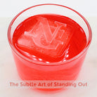 Custom NG monogram ice cube in a red cocktail – premium barware gift for stylish home bars.
