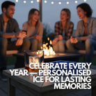 Close-up of a whisky glass with a large monogrammed ice cube marked “JD,” next to a blue 6-cube silicone ice tray on a timber table, with friends chatting around a firepit at night.