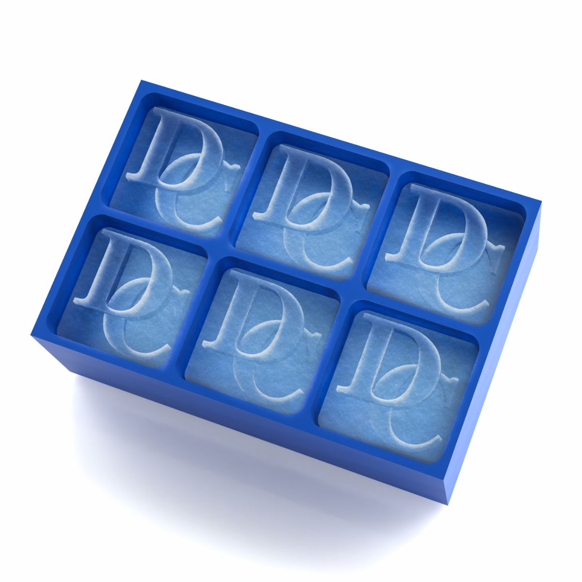 Close-up of a royal-blue platinum silicone tray creating six DC monogram ice cubes, handmade in Australia, perfect personalised keepsake for men