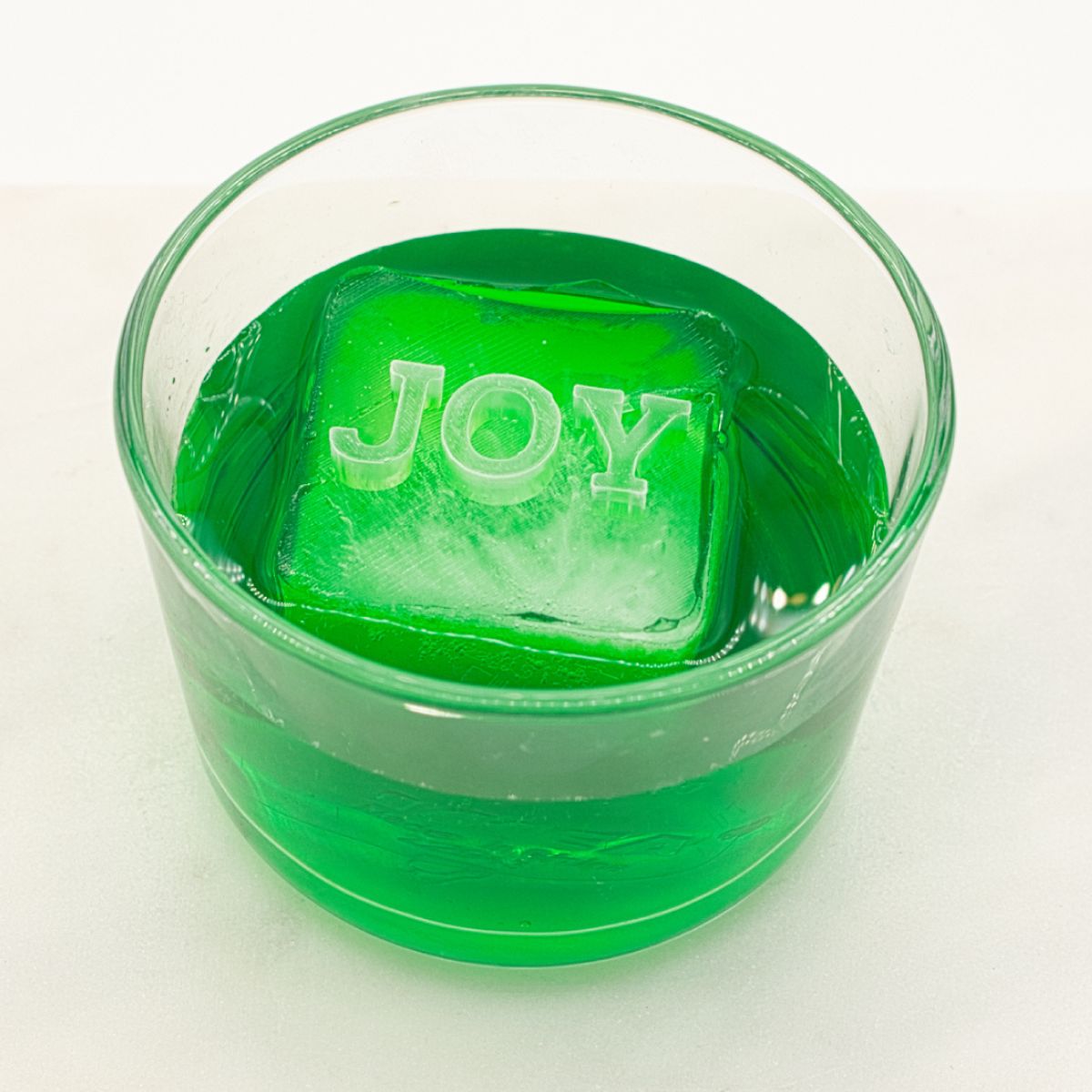 Spread happiness with a cube that reads JOY. Perfect for festive drinks, Christmas celebrations, or everyday cheer. Durable, handmade platinum-silicone design.