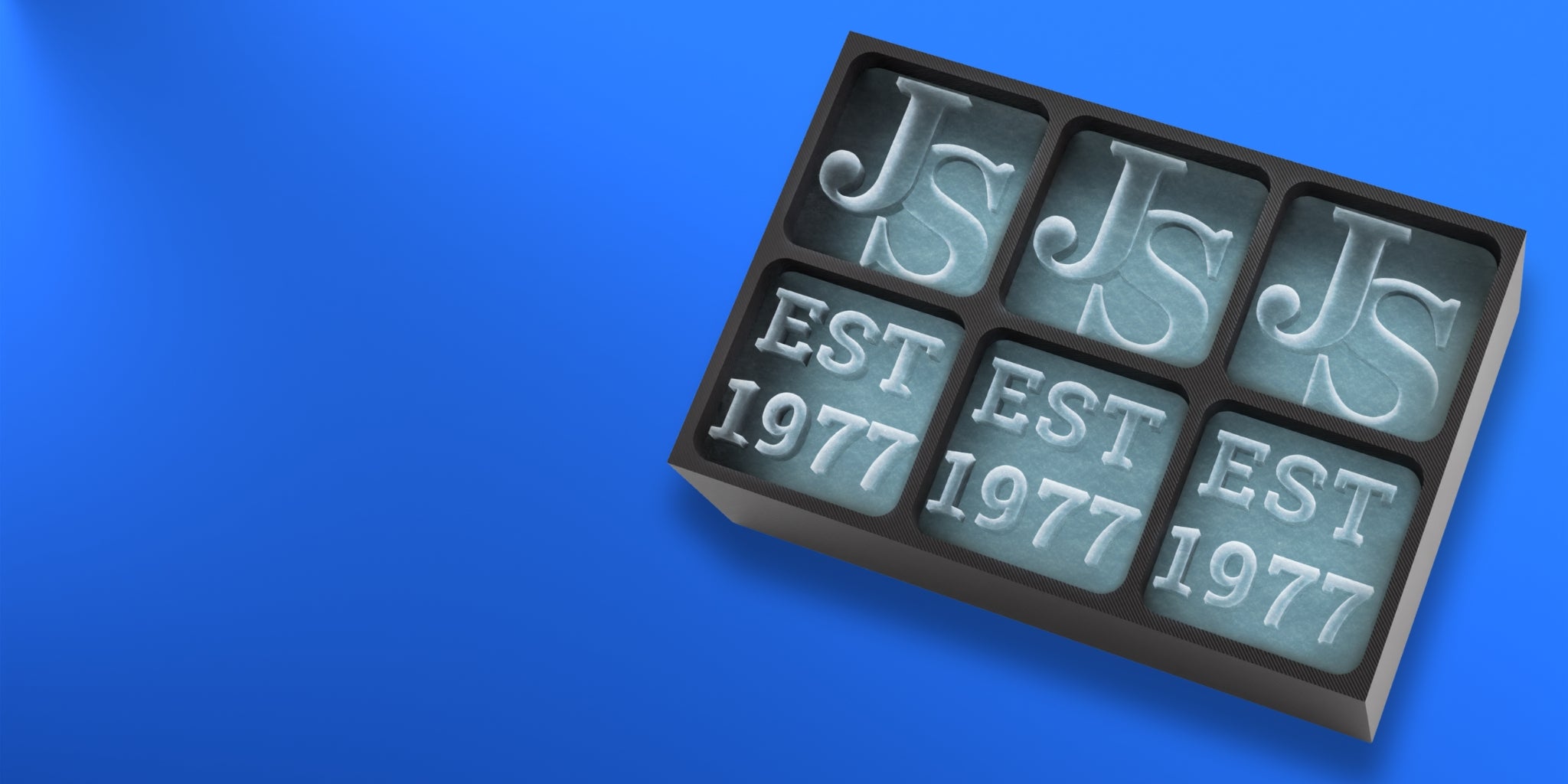Top-down view of a black silicone ice tray with personalised ice cubes showing 'JS' and 'EST 1977' – a custom gift idea for men born in 1977 or celebrating an anniversary, made by Chilled Out Creations