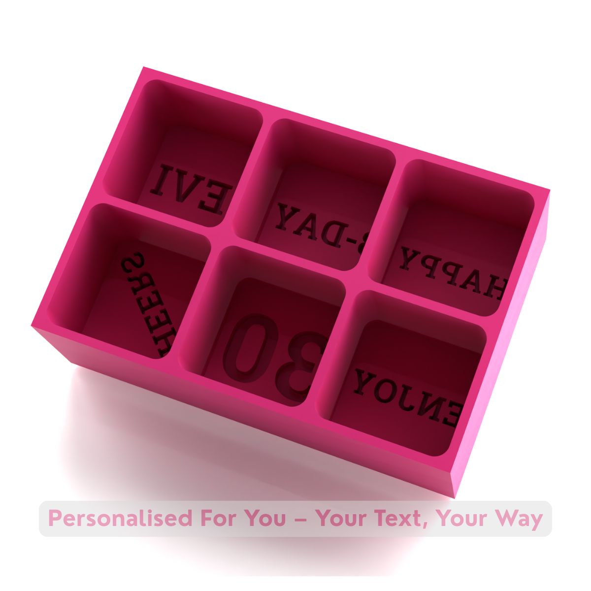 Pink silicone mold with letter impressions on a white background