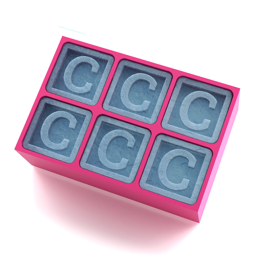 Pink silicone tray with personalised “C” ice cubes, a playful gift for men