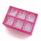 Pink silicone ice tray spelling 'LUCY 18', designed for unique birthday party drinks.