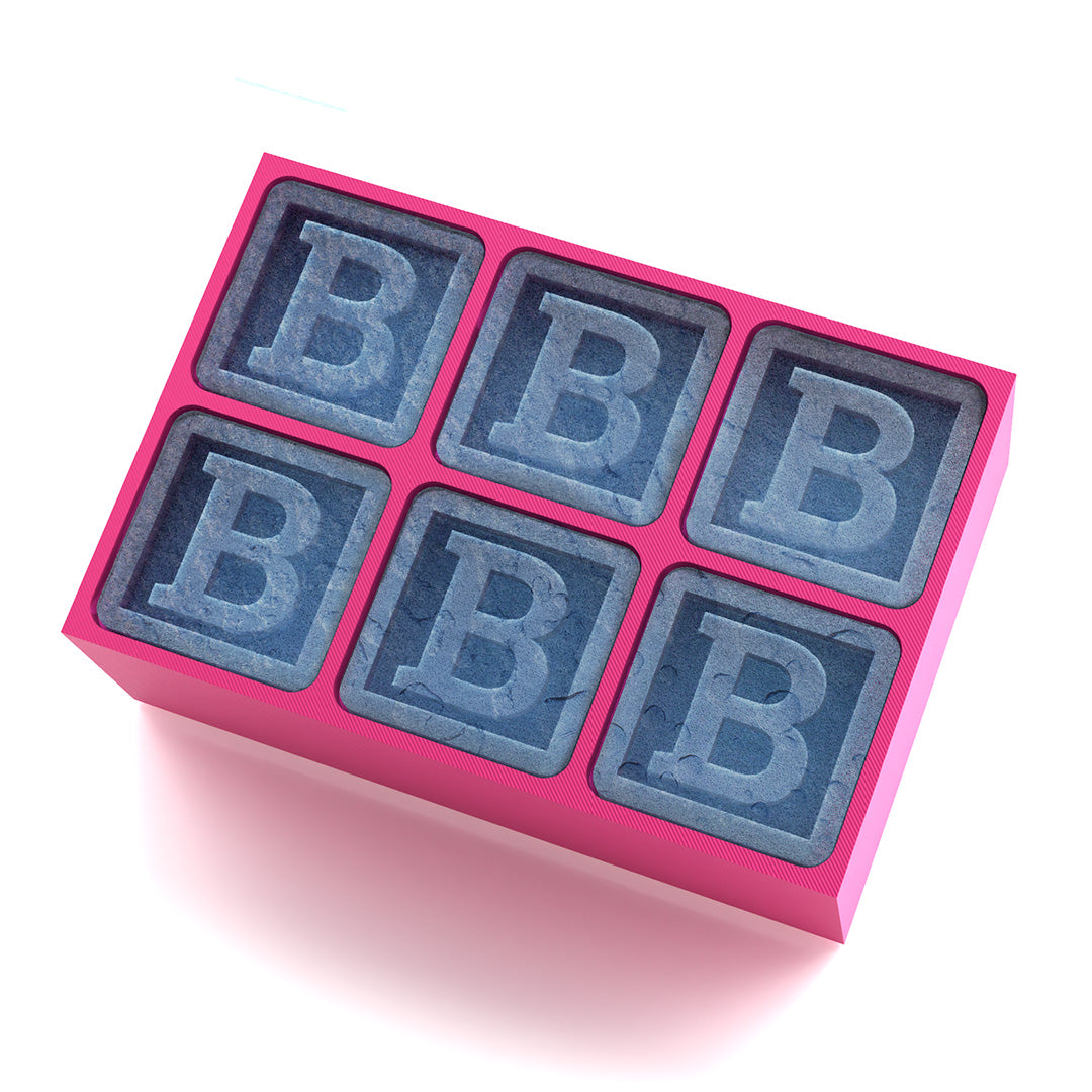 Pink silicone tray with signature B cubes – a thoughtful and playful gift for girls’ birthdays, events, and custom cocktails.