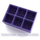 Deep purple silicone ice tray showing engraved initials and logos, creating stylish personalised ice cubes for gifting or events.