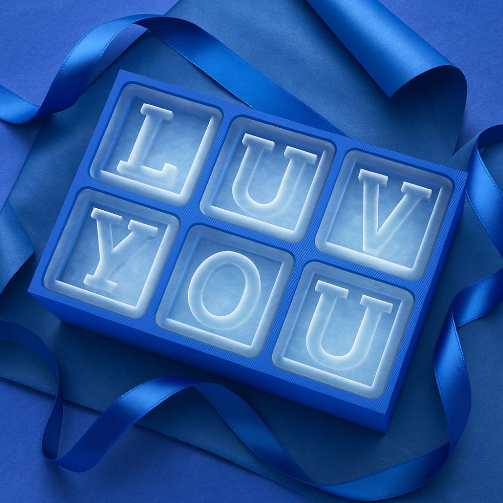 Romantic LUV YOU custom ice tray surrounded by deep blue ribbon – the perfect surprise when wondering what to get your boyfriend for his birthday.