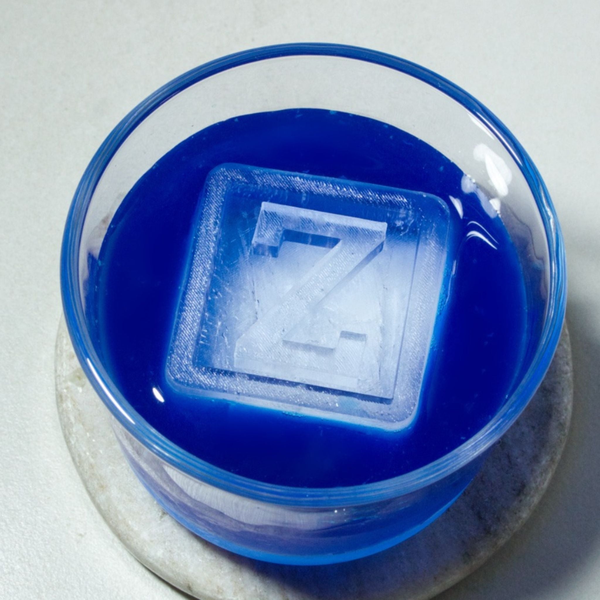 Personalised Z ice cube floating in vibrant blue drink, great for party or event marketing