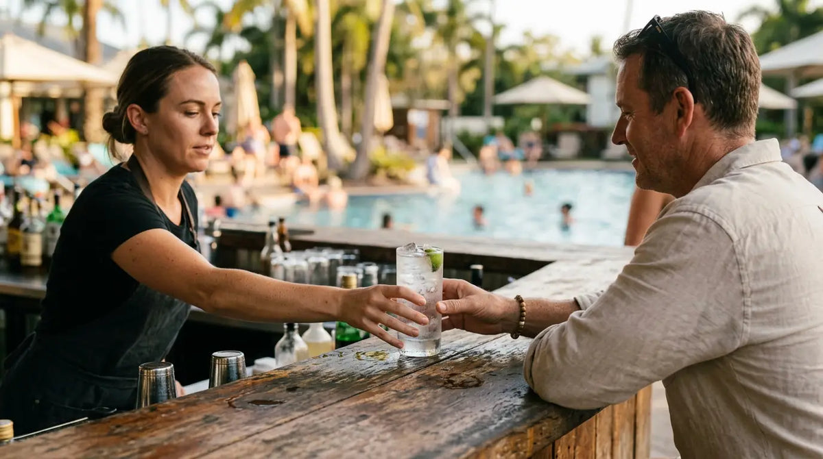 Resort poolside bar in Queensland with a bartender serving a highball over clear ice