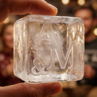 Close-up of a large custom A&M monogram ice cube held in hand at a party