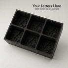 Personalized A&M monogram silicone ice cube tray in black that makes six custom initial cubes