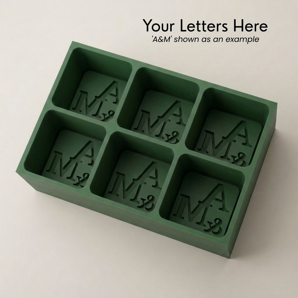 Personalized A&M monogram silicone ice cube tray in green that makes six custom initial cubes