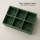 Personalized A&M monogram silicone ice cube tray in green that makes six custom initial cubes