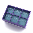 Purple custom silicone tray making standout ice cubes that read ARIA and LOVE – ideal for gifting.