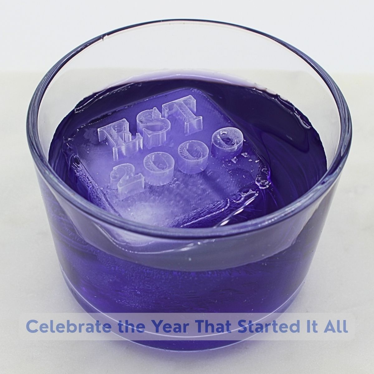 Purple cocktail with custom anniversary ice cubes featuring dates and numbers - romantic personalized drink celebration