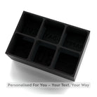 Black silicone ice cube tray with engraved text on a white background