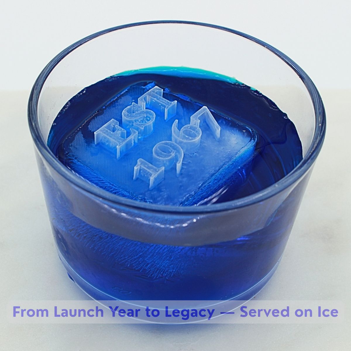 Blue drink with custom business anniversary ice cubes featuring EST date - corporate milestone celebration ice