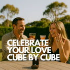 Couple celebrating their engagement outdoors with drinks featuring custom ice cubes, engagement ring in focus on the table, with bold text overlay reading “Celebrate Your Love – Cube by Cube.”