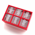 Red silicone mold with elf character shapes on a white background