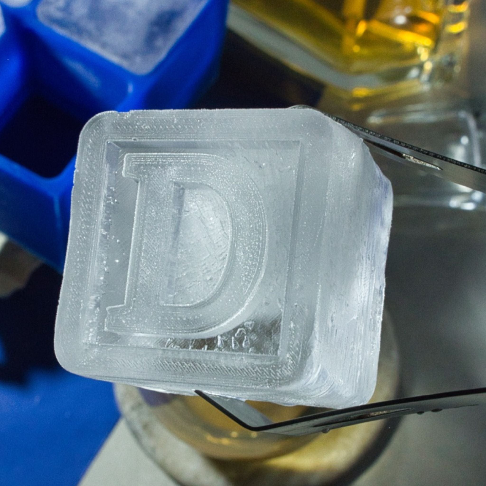 Detailed close-up of personalised D ice cube on a bar surface, highlighting clarity and premium handmade craftsmanship