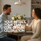 Happy couple clinking glasses at home with personalised ice cubes showing their initials and EST. year, celebrating love and milestones with a custom anniversary ice cube tray