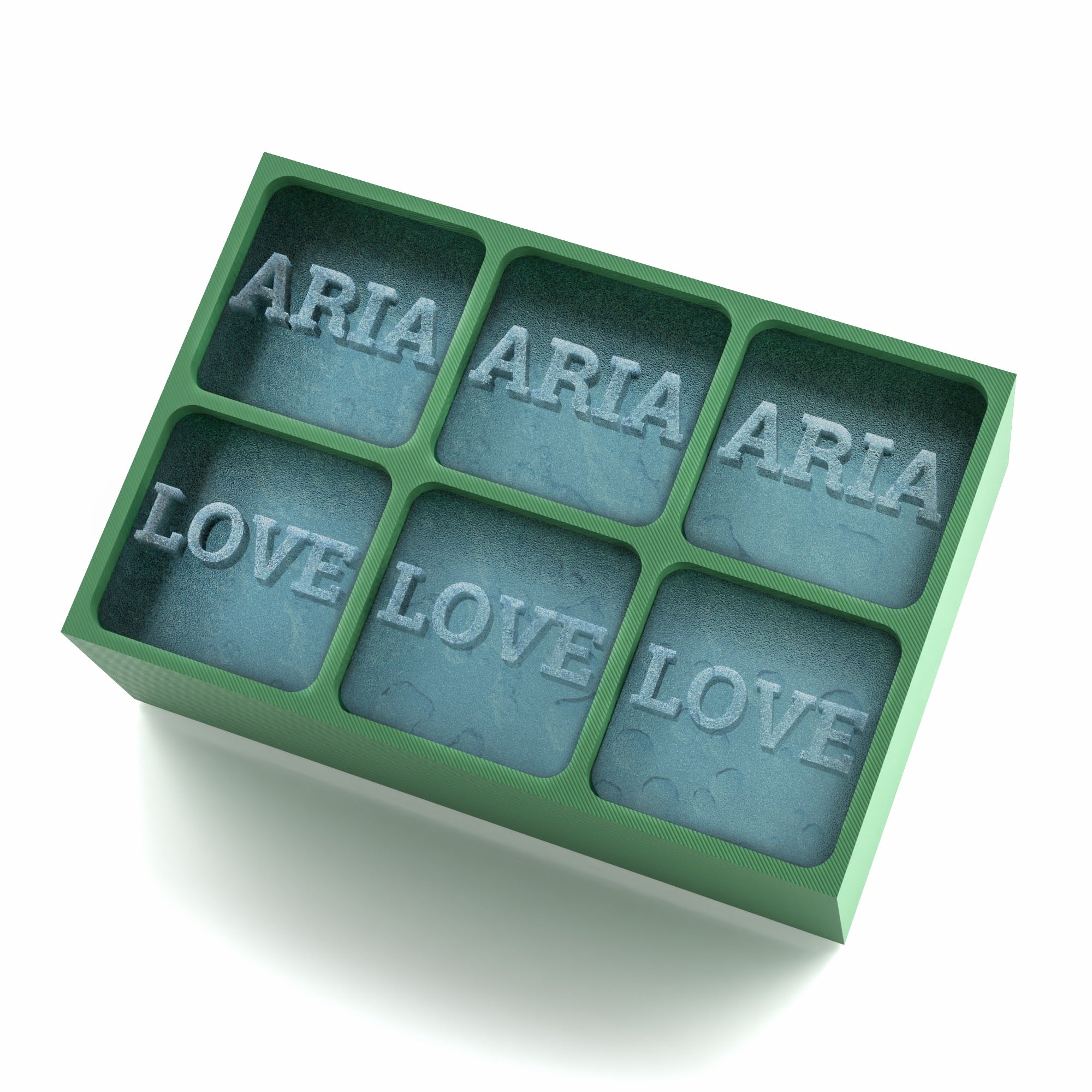Green silicone ice tray creating large customised ice cubes with the words ARIA and LOVE.
