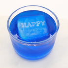 A raised “HAPPY” message ice cube floating in a bright blue drink, spreading positive energy with every sip.