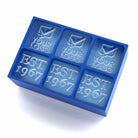 Blue 6-cube custom ice tray filled with personalized ice featuring YOUR LOGO text and EST 1967 date compartments