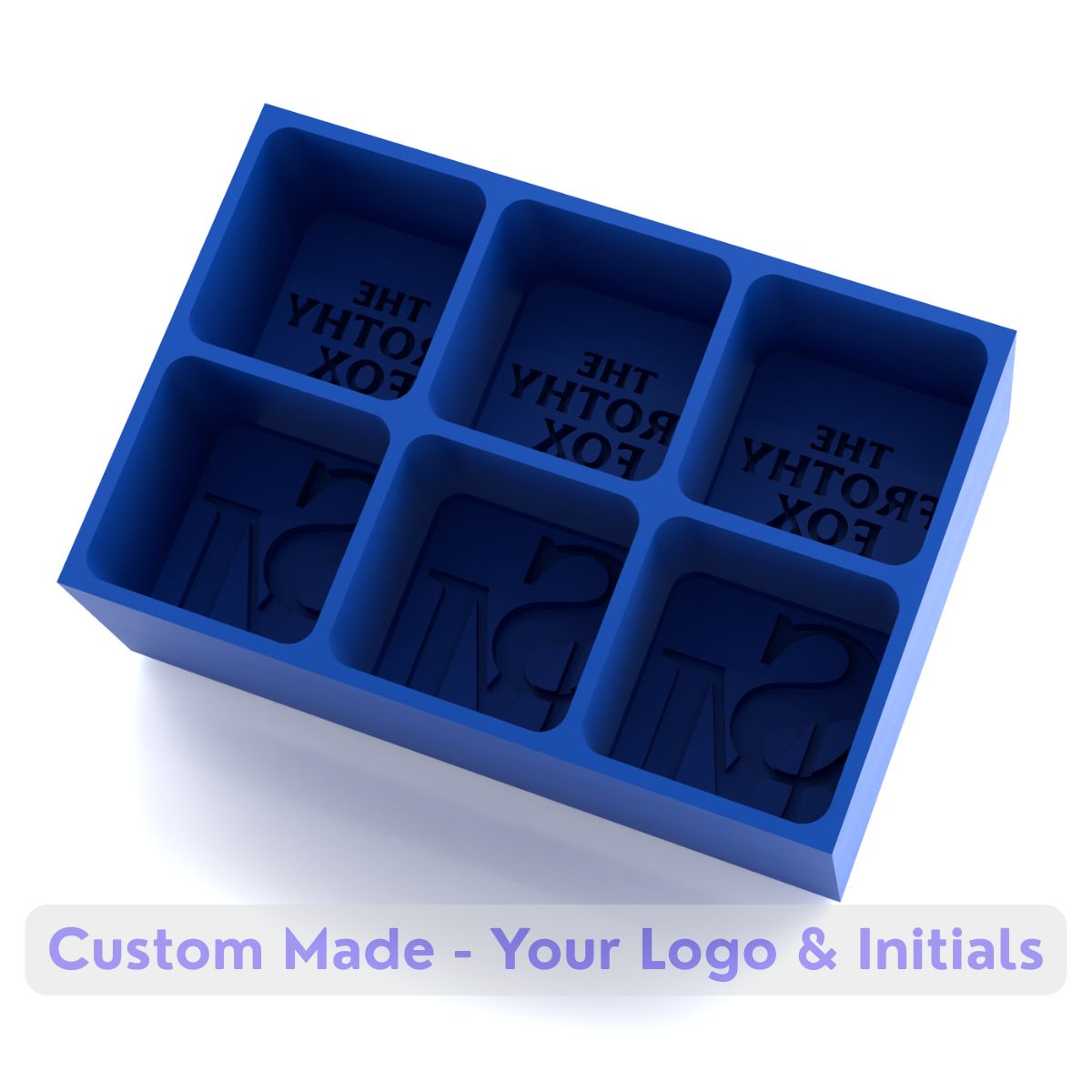 Blue silicone ice tray with six cavities for custom logos and initials, designed for The Frothy Fox branded bar ice cubes.