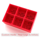 Red silicone tray producing six large ice cubes customised with The Frothy Fox bar’s logo and initials, ideal for drinks service.