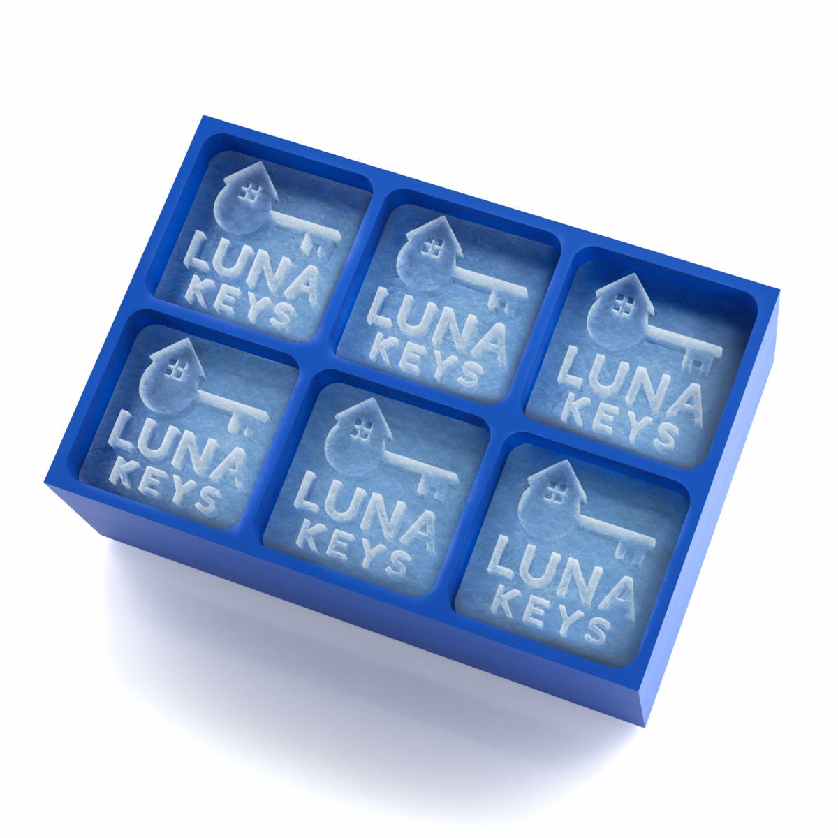 Close-up of blue silicone ice tray filled with 45mm ice cubes engraved with the “Luna Keys” house-and-key logo, showcasing crisp branding for real estate promotional gifts.