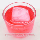 Red cocktail served with a DT monogram ice cube – unique personalised ice tray design.