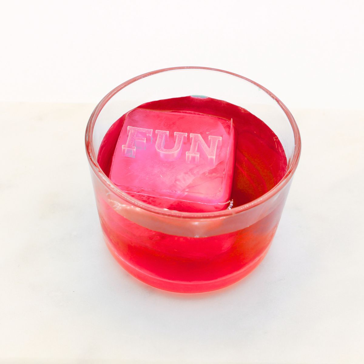 A bold red drink with a raised “FUN” ice cube floating on top, perfect for celebrations and light-hearted gifting moments.