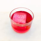 A bold red drink with a raised “FUN” ice cube floating on top, perfect for celebrations and light-hearted gifting moments.