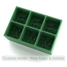 Handmade green silicone ice tray with six cube moulds, showing logo and initials, designed for gifts, branding, and special occasions.