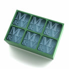 Soft green tray engraved with the initials M & V in every cube – a sentimental, sustainable gift idea for engagements, couples, or cocktail nights.