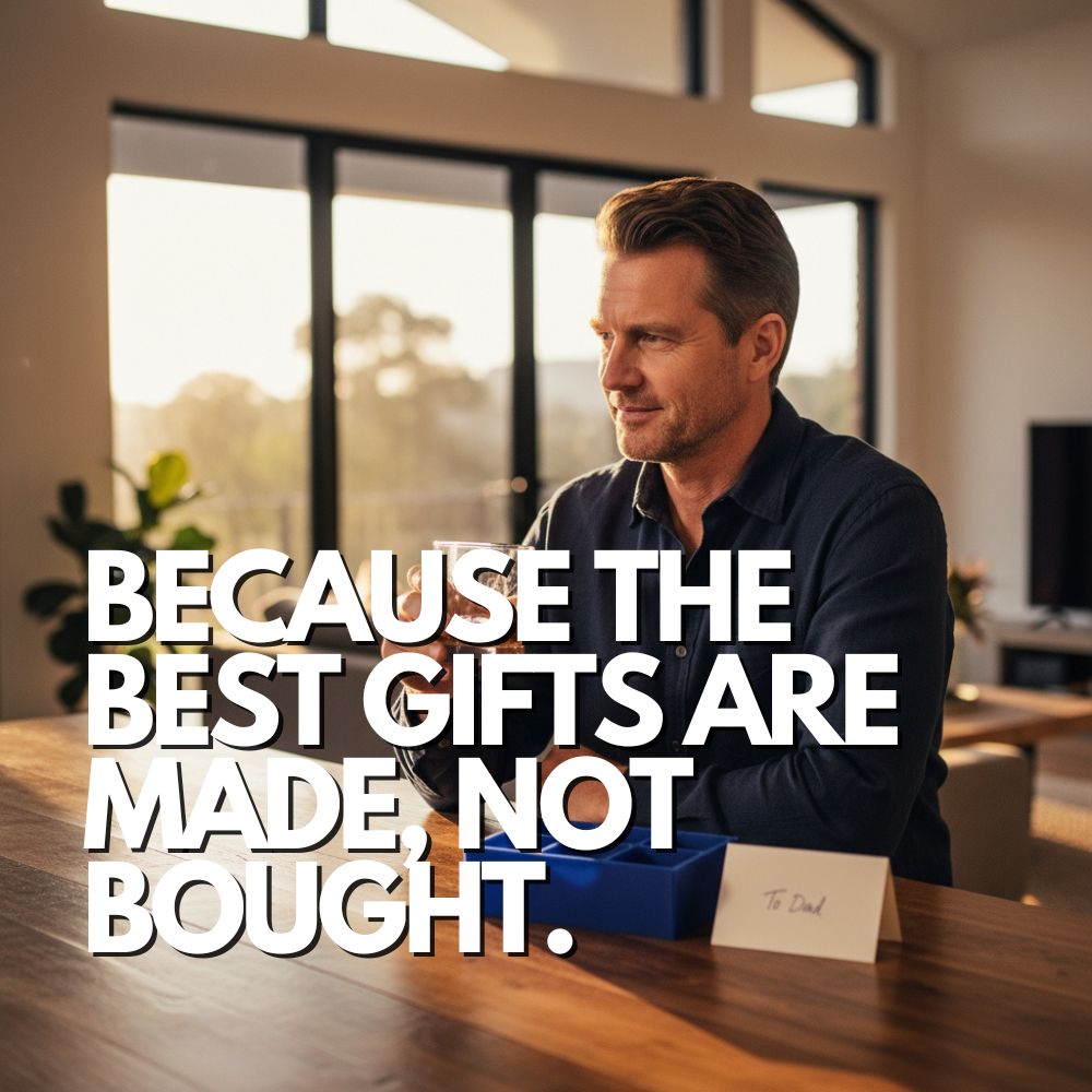 Middle-aged man sitting at a timber table with a whisky glass beside a royal blue silicone ice cube tray and a “To Dad” card, warm afternoon light filling the room. Text overlay reads “Because the best gifts are made, not bought.” A premium handmade Father’s Day gift for dads who have everything.