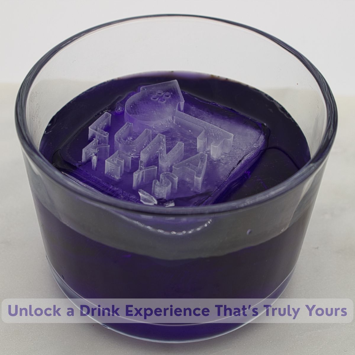 Purple drink with engraved key-shaped logo on ice cube, showing Luna Keys branding effect in glass