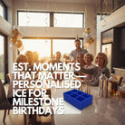 Family celebrating a milestone birthday at home with drinks and balloons, featuring a royal-blue personalised ice tray on the counter for custom initials and EST. year cubes.