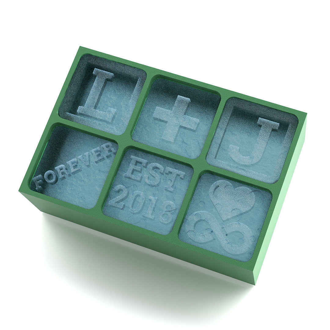Green silicone ice mould with six custom cube engravings including Forever, L+J, and heart icon – ideal wedding gift.
