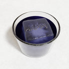 Purple beverage with a large HAPPY ice cube created using a premium silicone mould, symbolising custom design and craftsmanship from Chilled Out Creations.